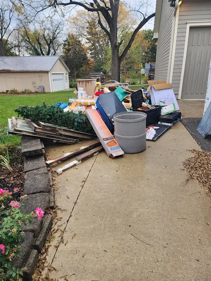 Dumpster being loaded with debris for Estate Cleanout Dumpster Rental in Pingree Grove